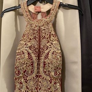 Long burgundy dress with gold lace on front and back of dress.  Backless